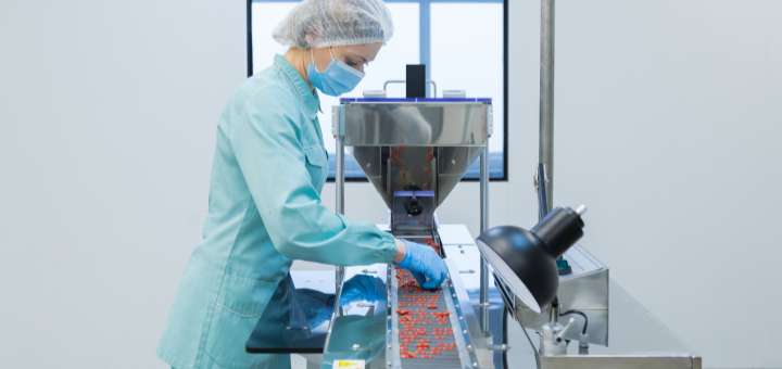 lab technician working on a conveyor belt