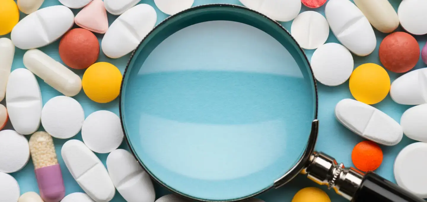 Magnifying glass with assorted pills